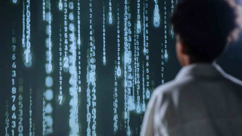 A boy is looking at some digits that look like the Matrix, symbolizing the importance of promo code hunting as one of the budgeting scenarios for high school students.