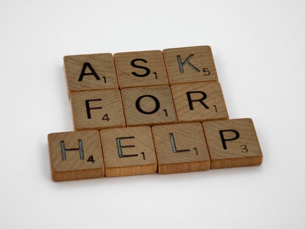 10 wooden blocks are there, and "AK FOR HELP" is written, emphasizing the importance of asking for money help to avoid debt collection.