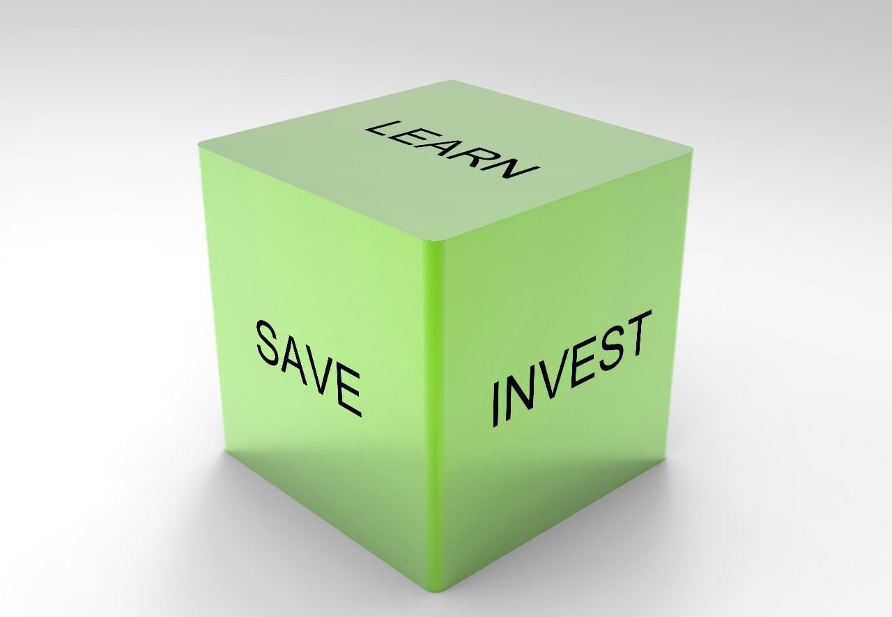 A green cube with the words “Learn,” “Save,” and “Invest,” symbolizing the habit of paying yourself first to build smart financial habits