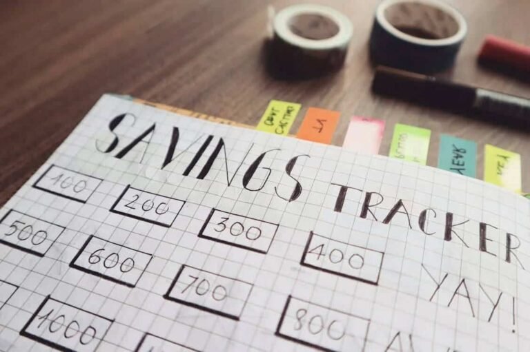 Hand-drawn savings tracker on graph paper, a visual reminder that the first priority in your budget should be building up your savings step by step.