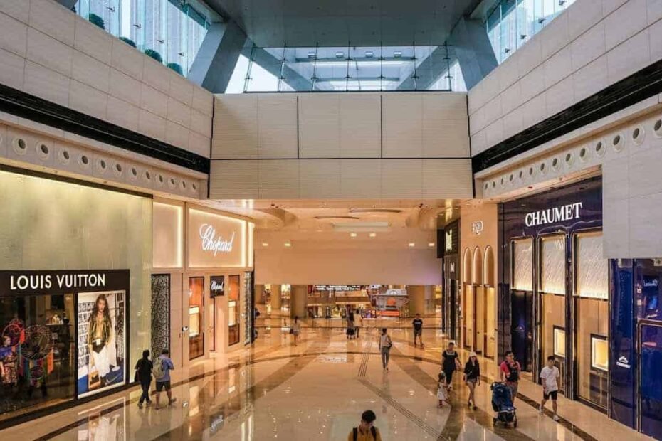 Teenagers walking through a luxury shopping mall, highlighting spending choices and financial decisions, representing the question of how much spending money a week is reasonable.