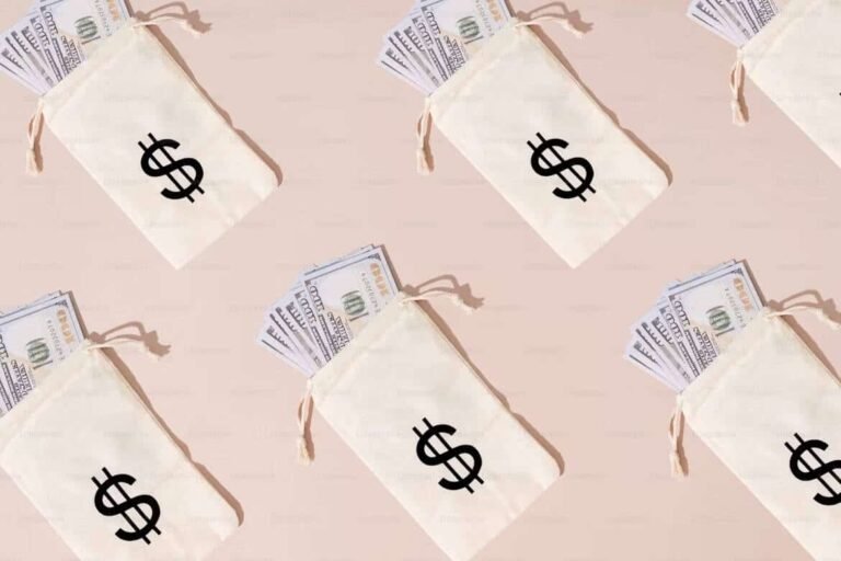 Multiple beige money pouches with bold dollar signs, each filled with stacks of U.S. hundred-dollar bills, laid out on a soft pink background. This image visually represents financial abundance and budgeting, tying into the question: how much spending a week is reasonable?—a reminder to align cash flow with smart money habits.