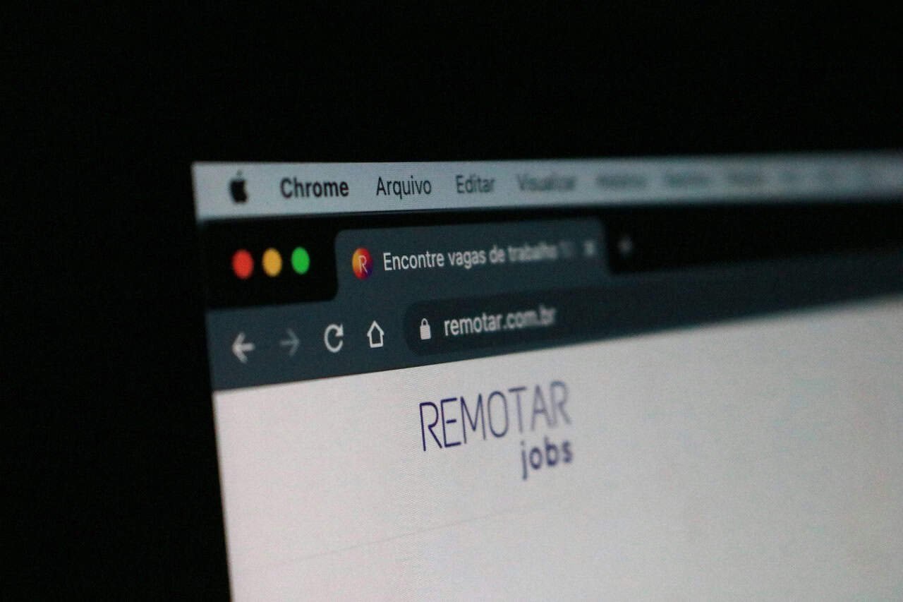 Teen browsing remote job opportunities on a computer screen.