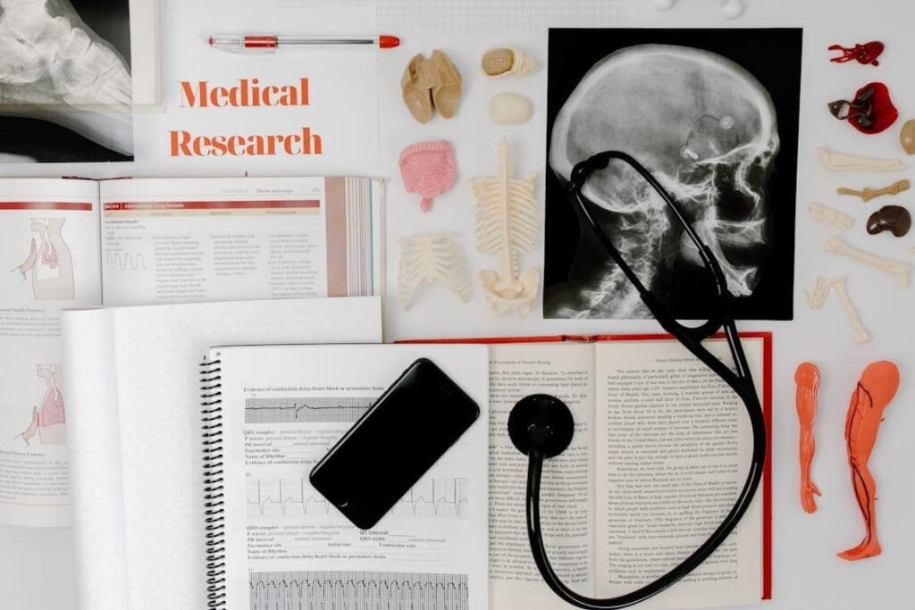 A desk covered in various medical items, including a skull X-ray, anatomical models, a stethoscope, and textbooks. The scene symbolizes a teenager's aspiration and hard work in medical research or studies.