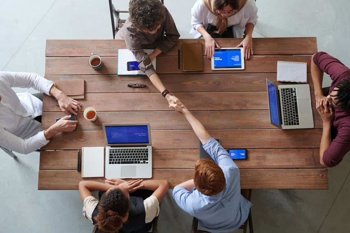 Realistic teens and young adults connecting via devices, promoting smart youth budgeting support.