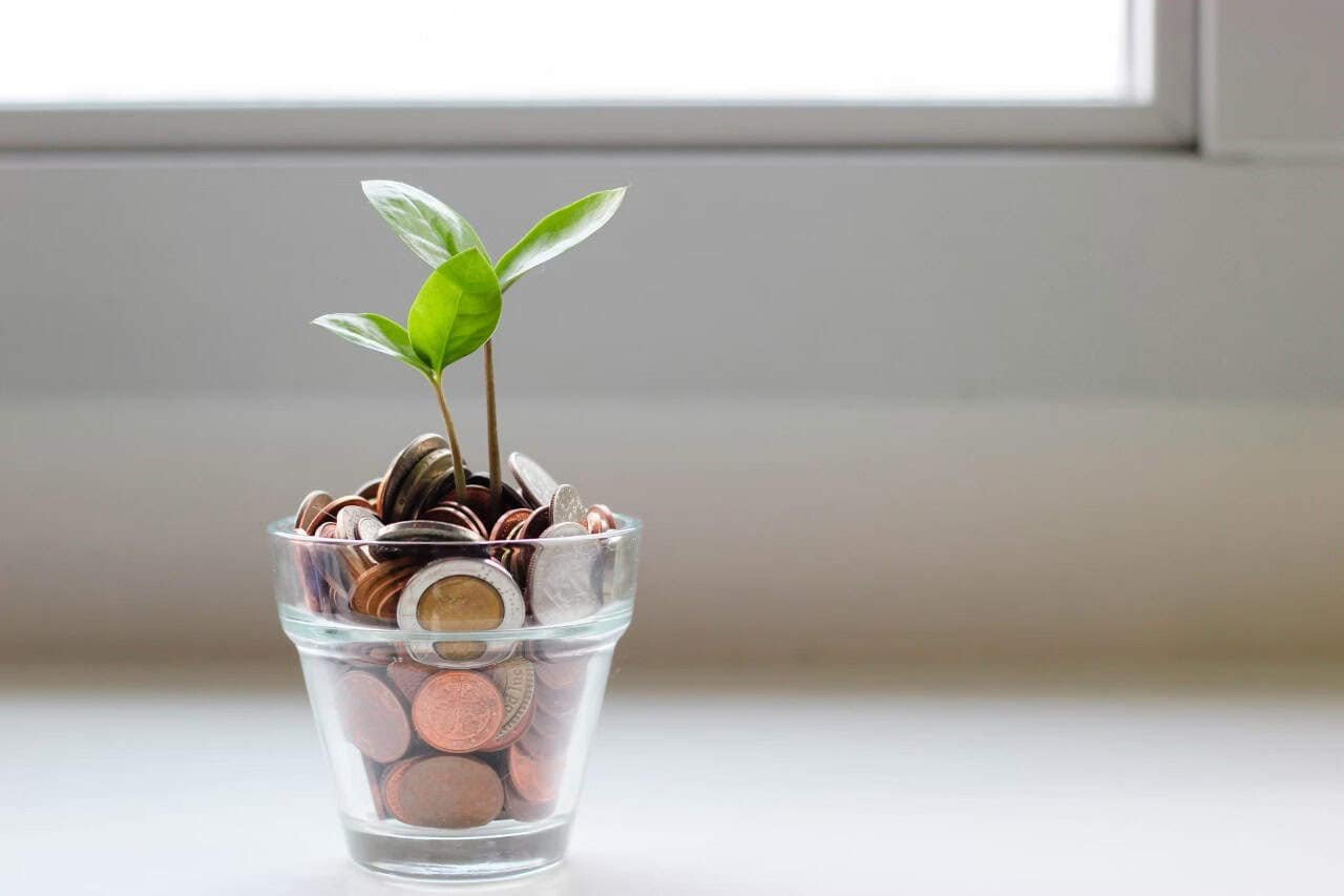 Saving money in a dedicated account, allowing your funds to grow over time for a large purchase