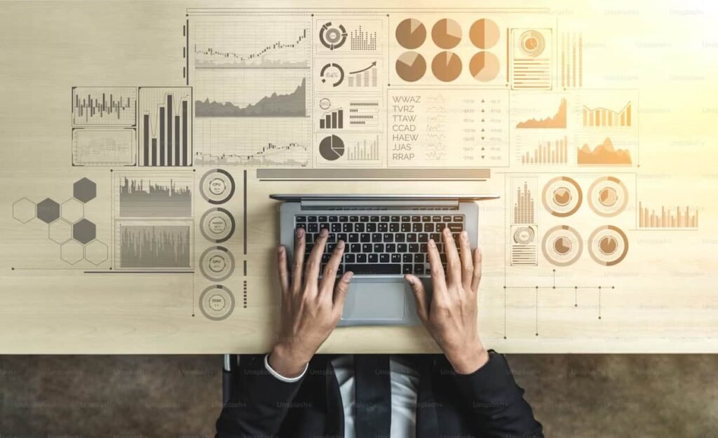 Hands on laptop keyboard analyzing financial data, budgeting charts and performance graphs for freelance income planning.