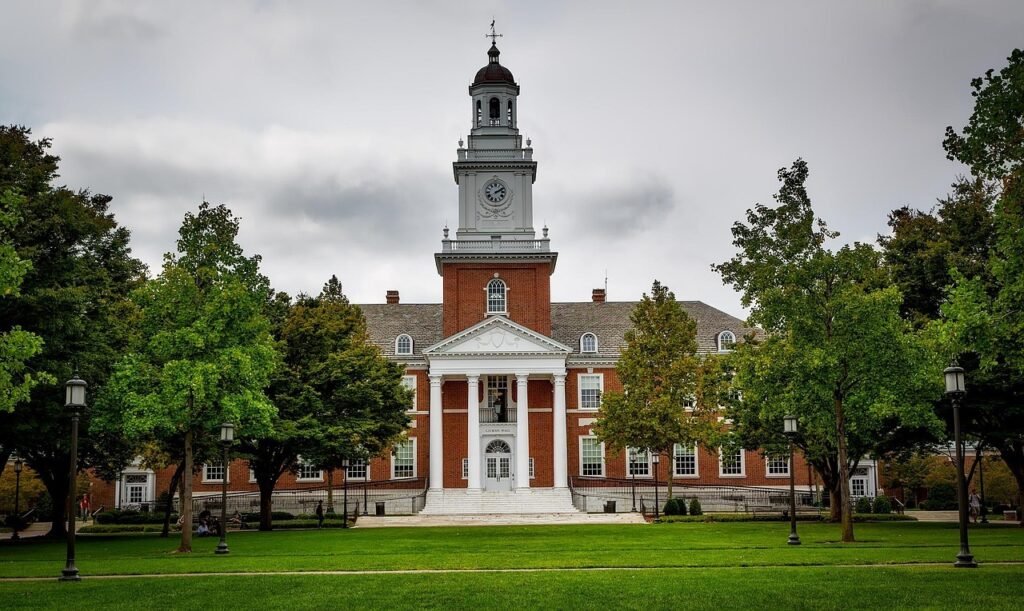 Public university campus building with clock tower and trees