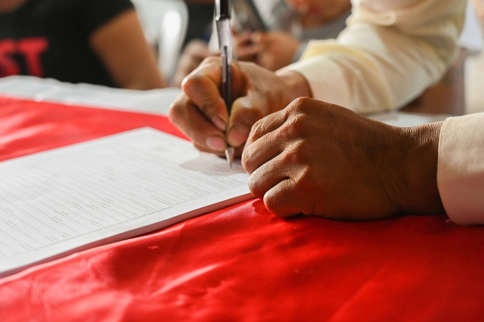Student signing financial aid form to start FAFSA application – how can we lower college tuition